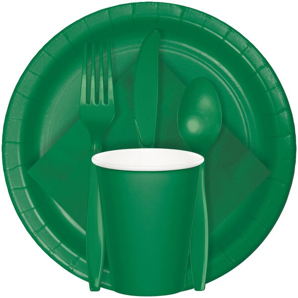A close up of a Creative Converting emerald green paper plate with a fork, spoon, and cup.
