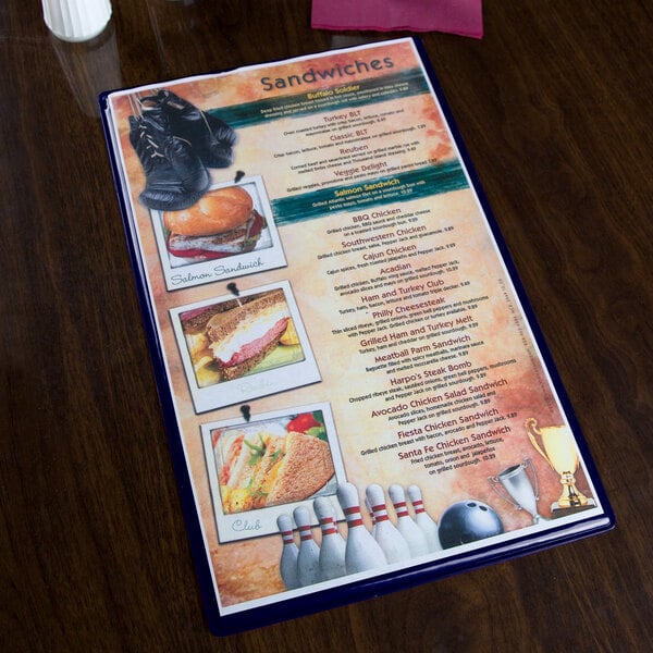 A dark blue Hamilton menu board on a table with a menu inside.