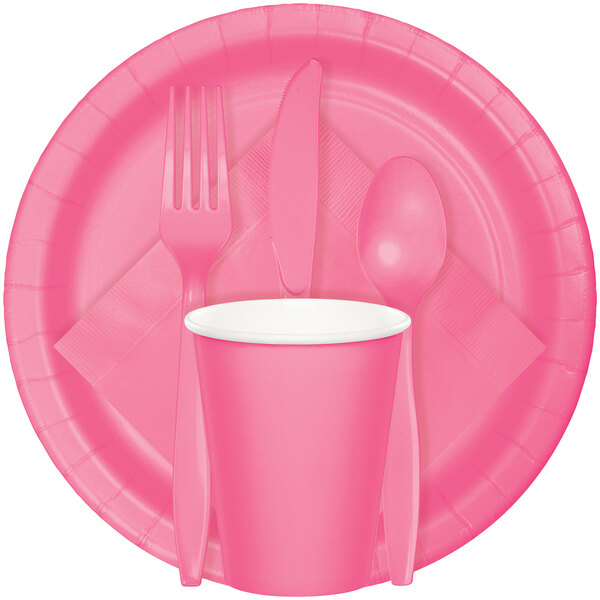 A Creative Converting candy pink paper plate with a fork and spoon on it.