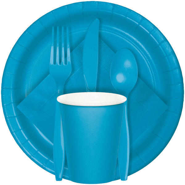 A turquoise blue paper plate with white circles.