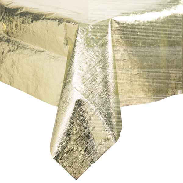 A gold metallic Creative Converting table cover on a white table.
