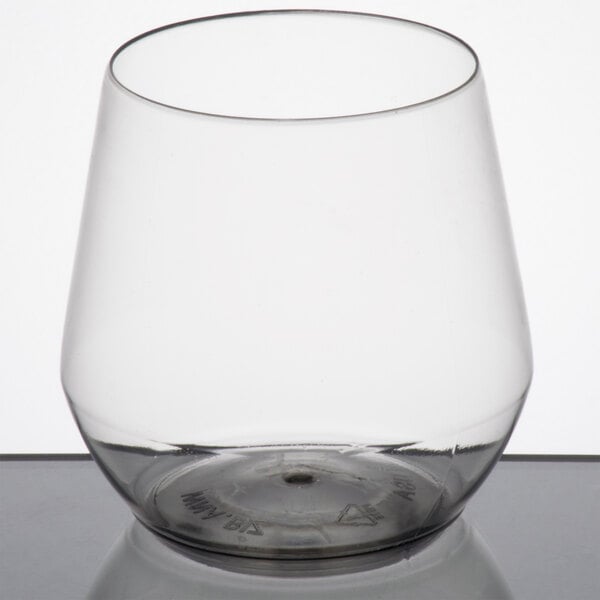 A clear plastic stemless wine goblet with a silver base.