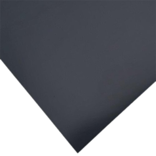 A close-up of a black sheet of paper with a white corner