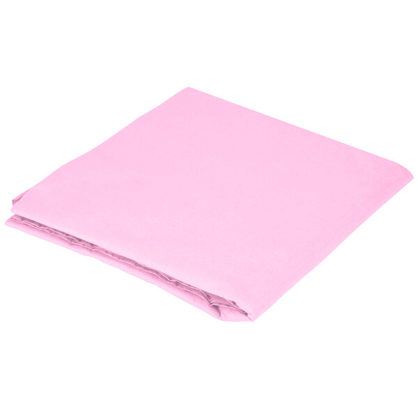 A folded pink Creative Converting table cover on a white background.