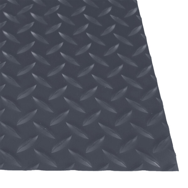 A close-up of a gray rubber diamond plate surface on a Cactus Mat.