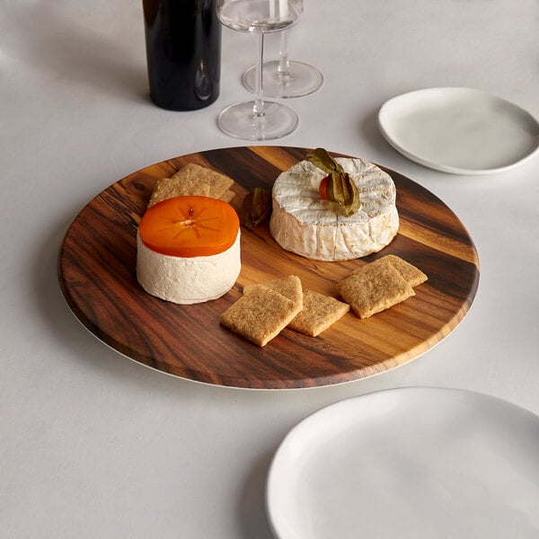 An American Metalcraft faux acacia melamine charger with cheese and crackers on it.