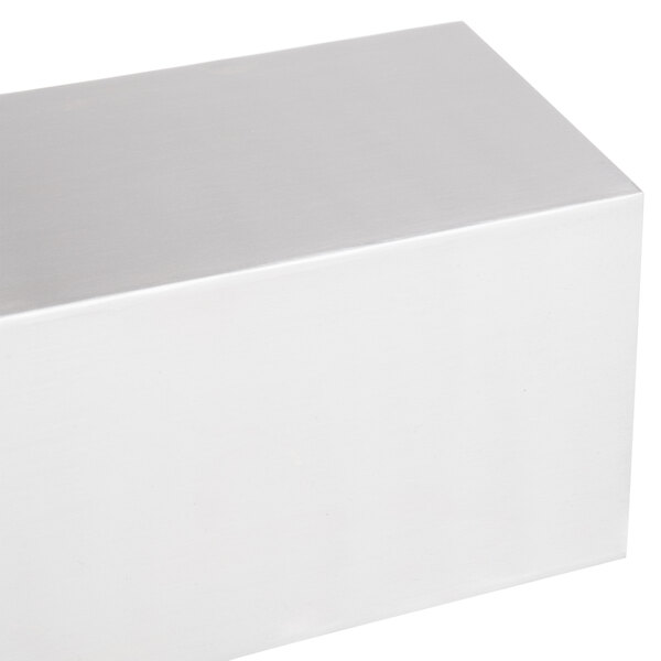 An American Metalcraft stainless steel rectangular riser in a white box on a white surface.