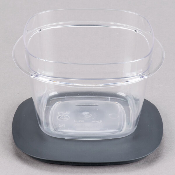 A Rubbermaid clear plastic container with a lid on a black surface.