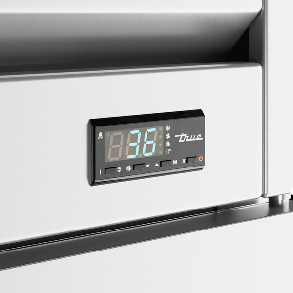 A digital display on a white surface with numbers and buttons.