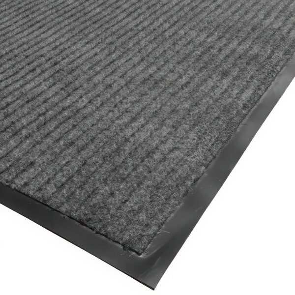 A close up of a gray needle rib carpet mat with a black border.
