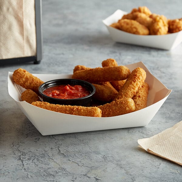 A #300 white paper food tray filled with fried food and red sauce on a table.