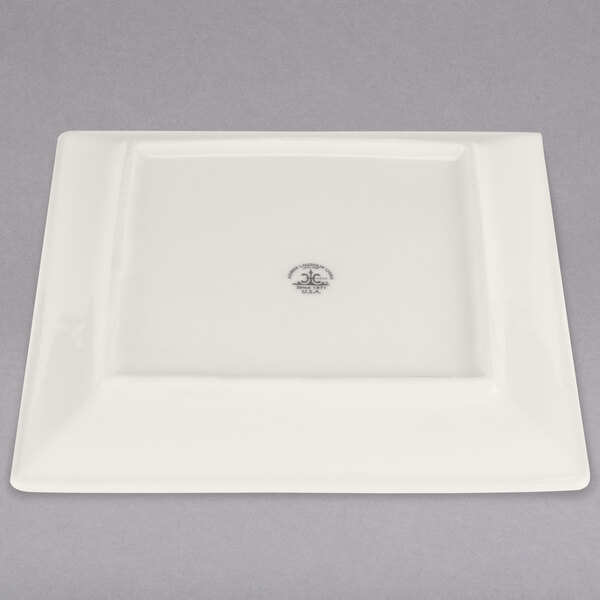 A white square Homer Laughlin china plate with a logo in the middle.