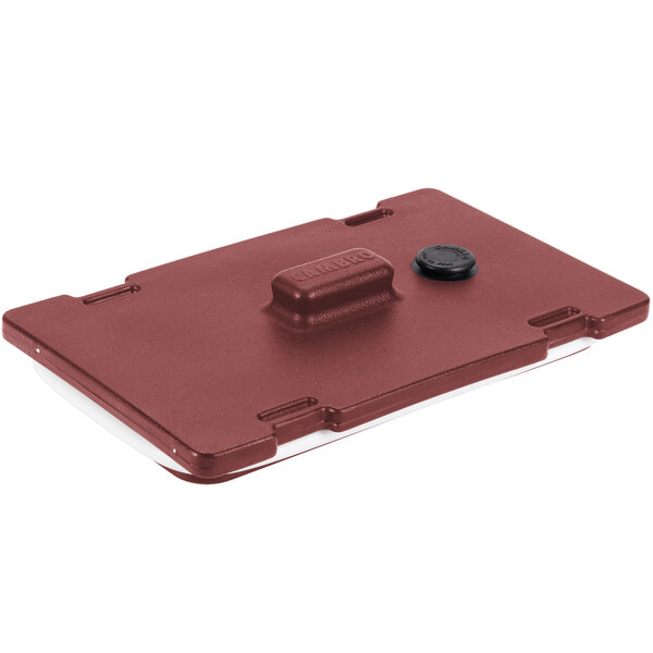 A red plastic Cambro Camtainer lid with a black rectangular button.