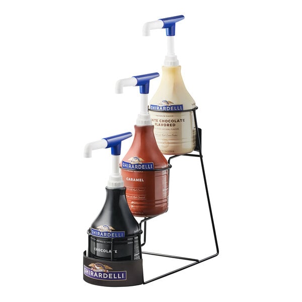 A Ghirardelli 3-tier flavoring sauce rack holding bottles of flavoring sauce.