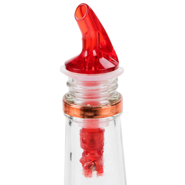 A Tablecraft measured liquor pourer with a clear bottle and a red spout.