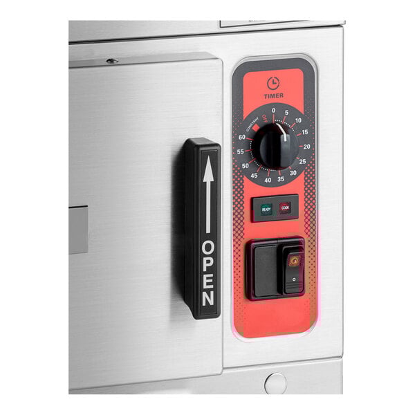 A stainless steel electric countertop convection steamer with a black handle labeled 'OPEN' and a red control panel featuring a timer dial, indicator lights, and a power switch.