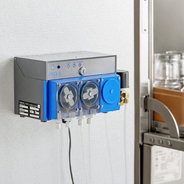 A Viking Pro V Three Warewashing Chemical Pump machine on a shelf with a glass jar.