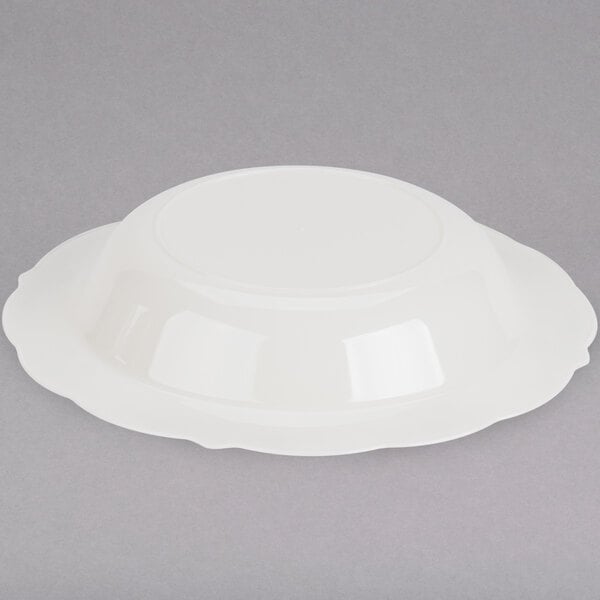 A white Fineline disposable plastic bowl with a gold rim.