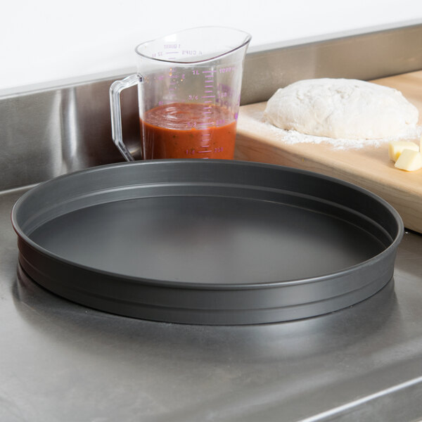 An American Metalcraft hard coat anodized aluminum cake pan on a counter.