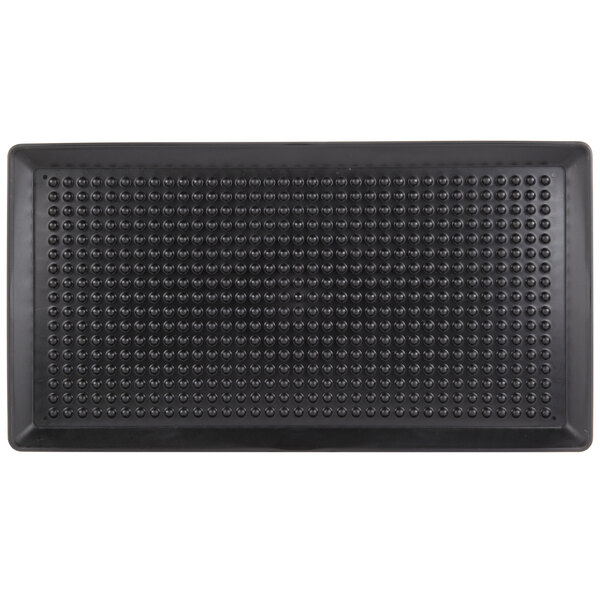 A black rectangular mat with small circles.