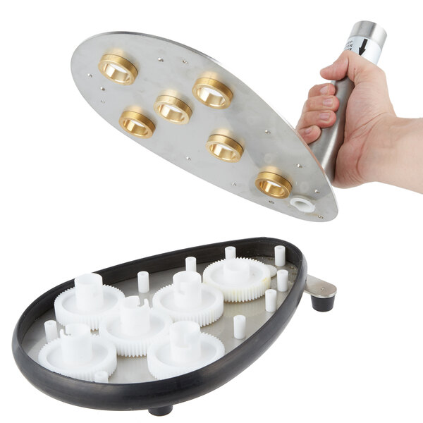 A hand holding the Noble Products Upper Shaft Bearing for a glass washer.