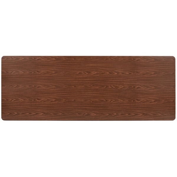 A rectangular walnut wood table top.