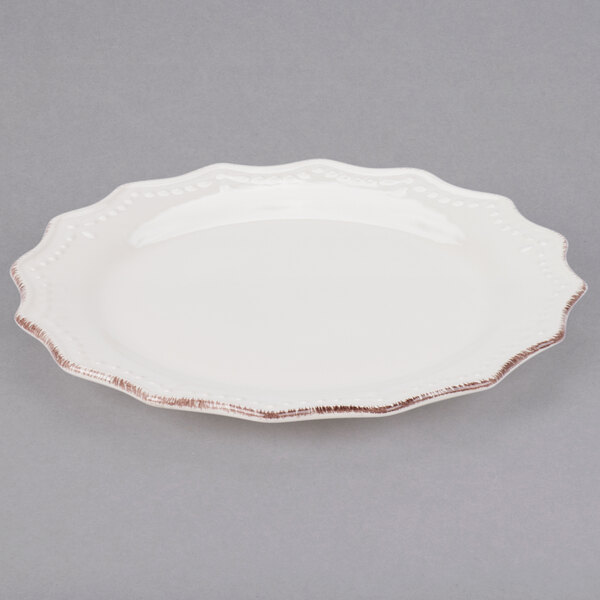 A white stoneware plate with a brown rim.