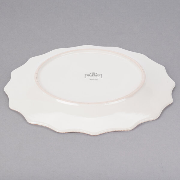 A white stoneware plate with a brown rim 