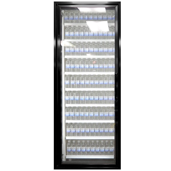 A Styleline walk-in cooler glass door with shelving full of water bottles.