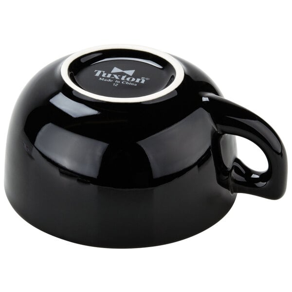 a black teapot with a handle