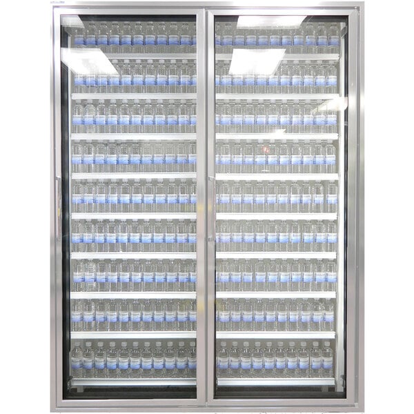 A Styleline walk-in cooler merchandiser with glass doors full of bottles of water.