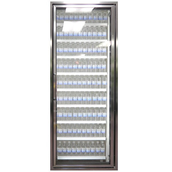 A Styleline Classic Plus walk-in cooler door with shelves full of water bottles.