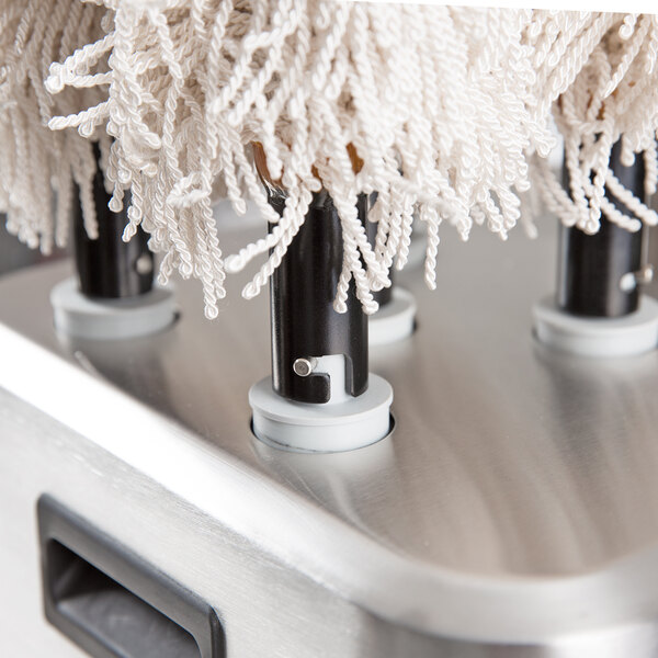A Bar Maid polishing head set on a counter.