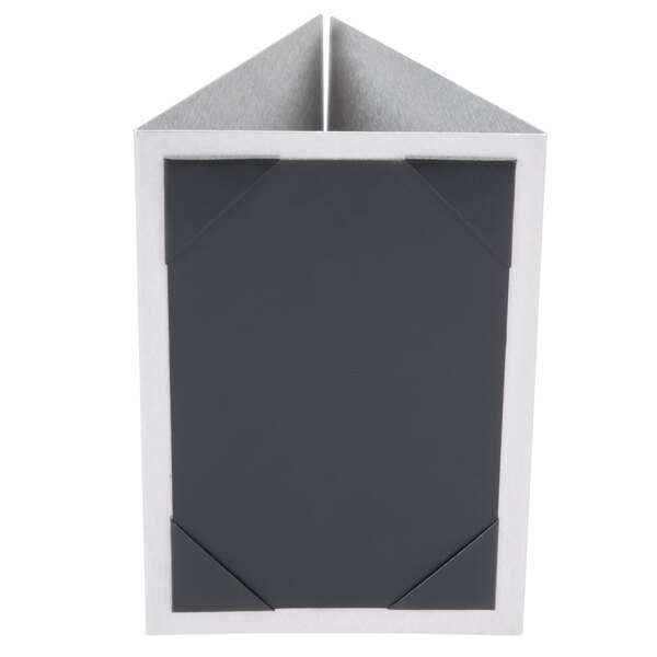 A brushed aluminum Menu Solutions table tent with black and white square design on a piece of paper.