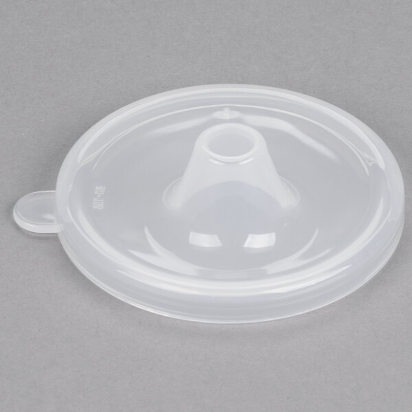 A close up of a clear plastic GET lid with a small opening.