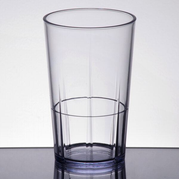 A clear plastic tumbler with a clear rim containing water.