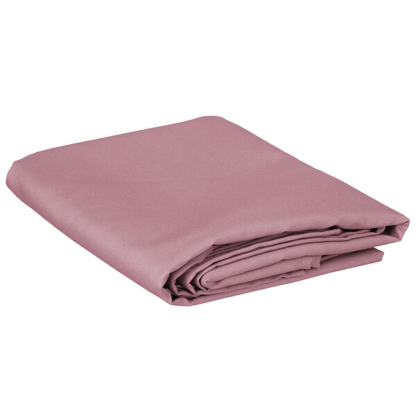 A folded pink table cover on a white background.