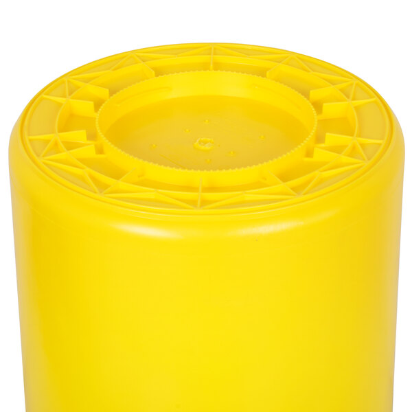 A yellow plastic Continental Huskee trash can with a circular lid.