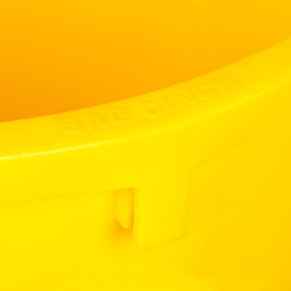 A close up of a yellow Continental Huskee trash can with a lid.