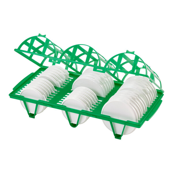 A green Cambro Camrack wash and store rack holding multiple white plates.