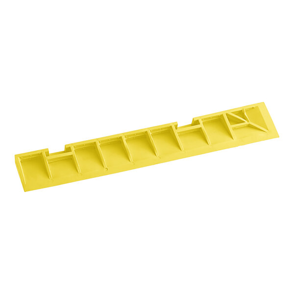 A yellow plastic Cactus Mat corner ramp with holes.