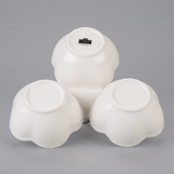 A 10 Strawberry Street Whittier white porcelain bowl caddy with three bowls stacked inside.