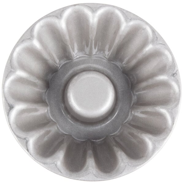 A Chicago Metallic aluminized steel lava cake pan with a flower design on the bottom.