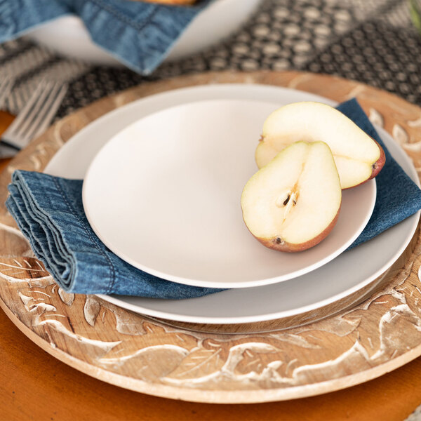 A white 10 Strawberry Street Wazee Matte stoneware salad plate with a pear half on it.