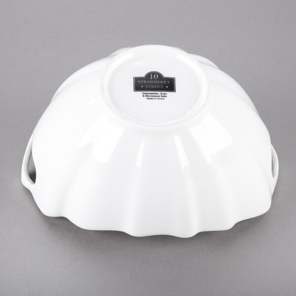 A white boat-shaped bowl with wave texture.