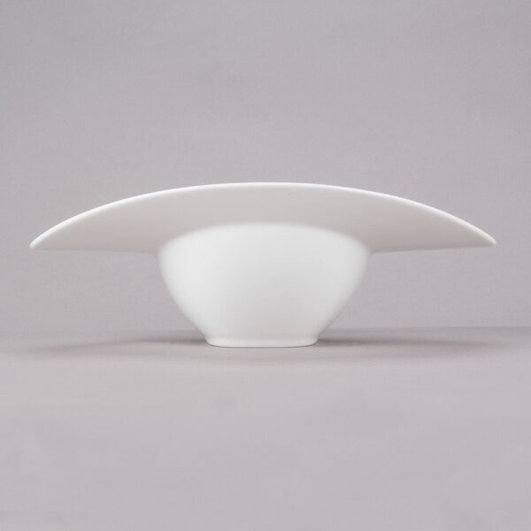 A close-up of a 10 Strawberry Street Somba white porcelain rim bowl.