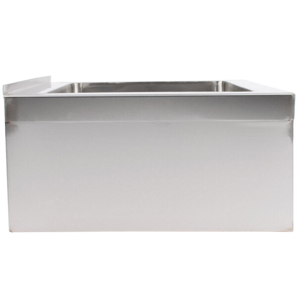 A stainless steel floor mounted mop sink with a drain.