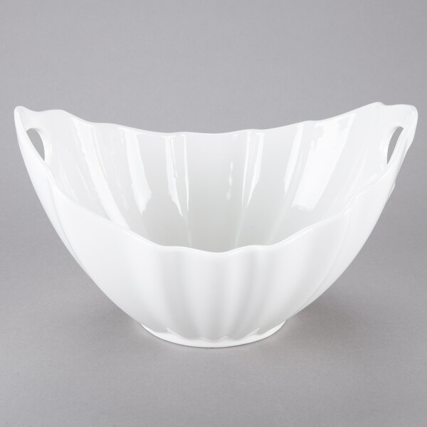 A white porcelain boat bowl with wave texture and handles.