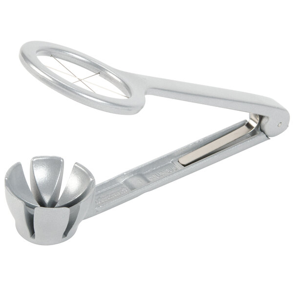 A silver Westmark egg wedger with a round object on the end.