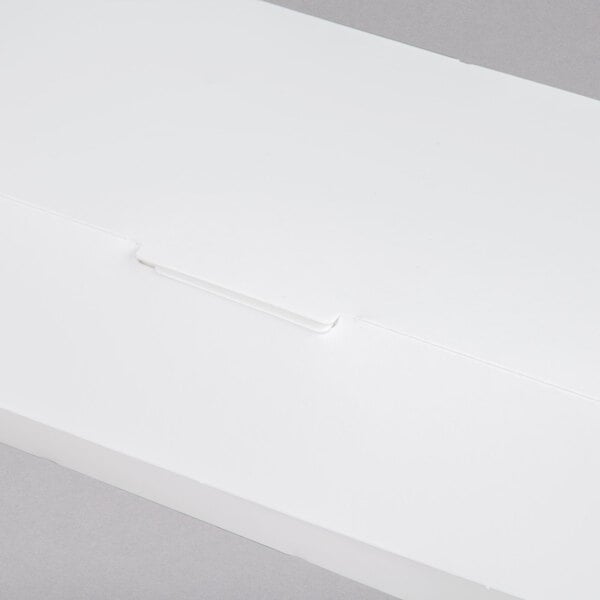 A white paper sandwich clamshell container with a clip.